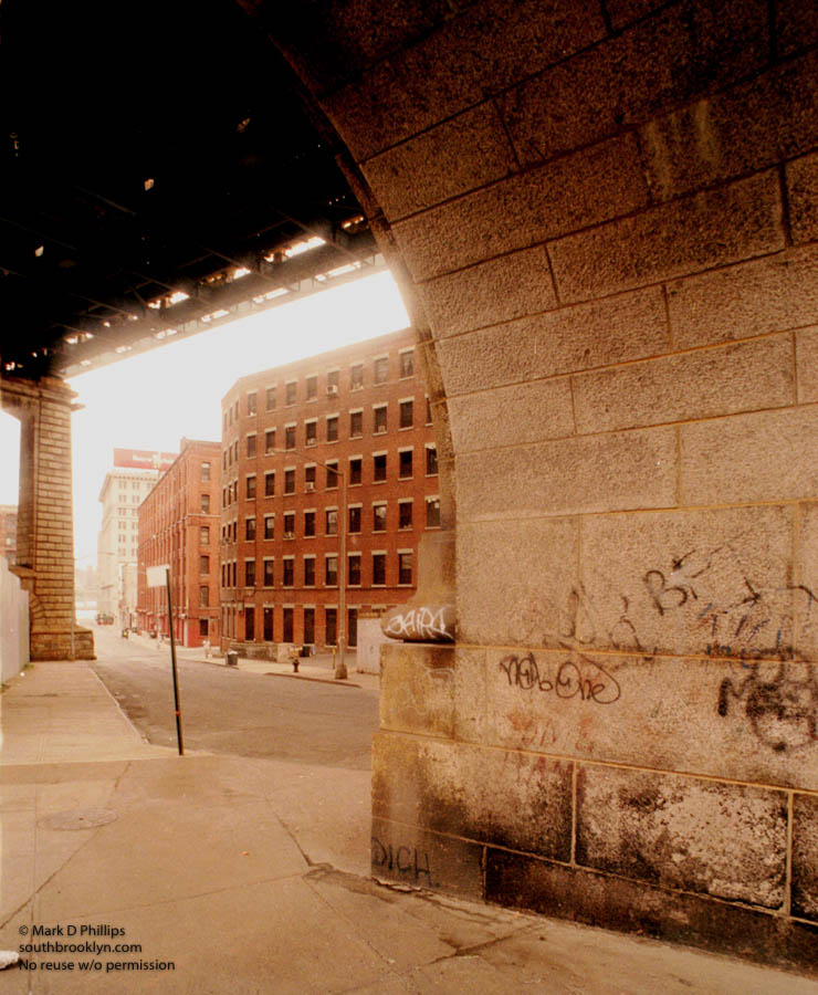 PRE-GENTRIFICATION: Under the Manhattan Bridge overpass in Brooklyn, DUMBO is the new SOHO of New York City. With warehouse buildings that are being converted to loft apartments, the area is undergoing rapid transformations. ©Mark D Phillips
