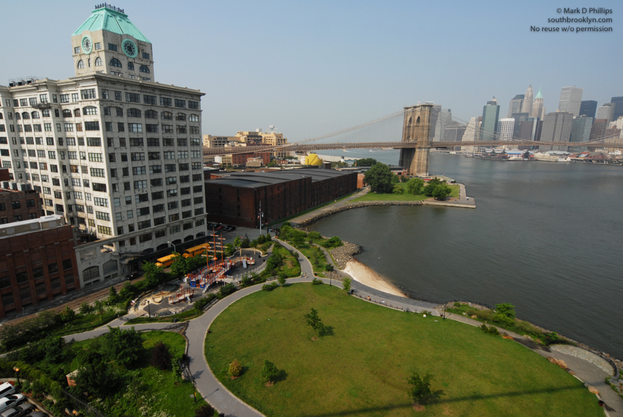 The Sweeney Building, Brooklyn Bridge Park, Brooklyn Bridge, Tobacco Warehouse, Fulton-Ferry State Park, East River, and lower Manhattan all come together in DUMBO from the walkway on the Manhattan Bridge. ©Mark D Phillips