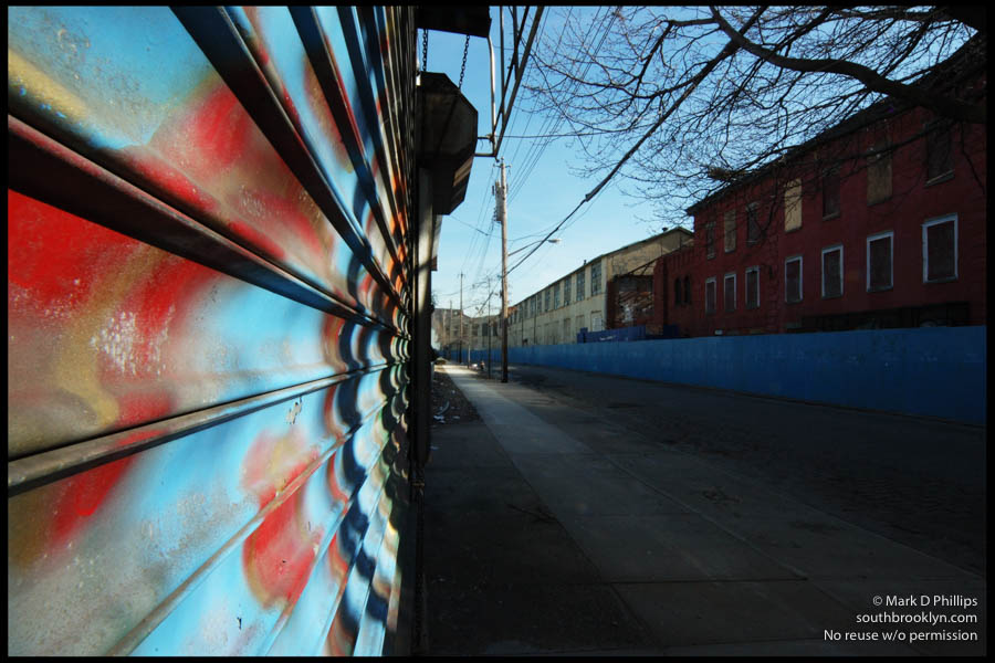 LONG GONE<br><br>The old Todd Shipyard buildings on Beard Street stand behind blue fences across from a failed bar on March 8, 2006, just prior to destruction for the new Ikea. The Red Hook section of Brooklyn is seeing major change as urban renewal hits full force. ©Mark D Phillips