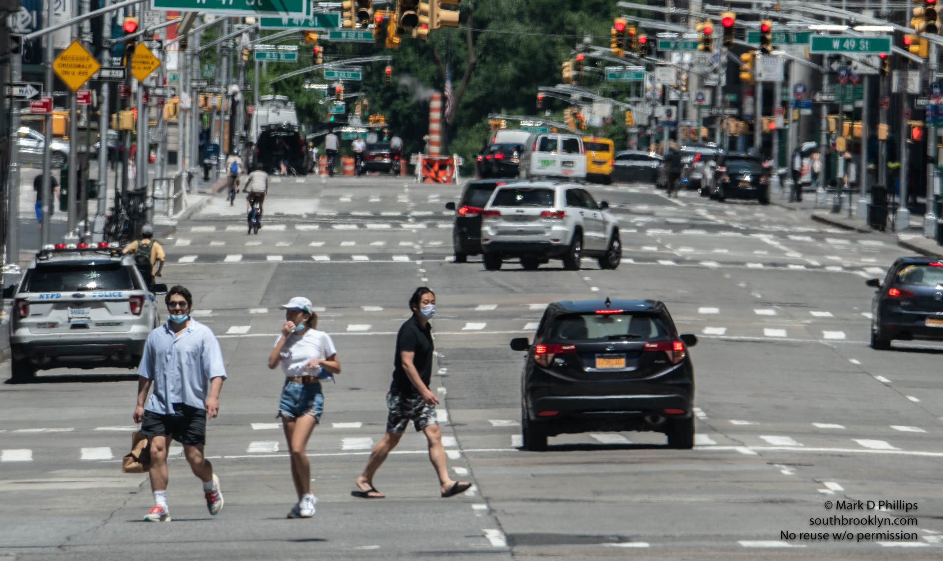 New York City on May 30, 2020, during the Covid-19 pandemic. Pedestrians and vehicles enjoy the emptiness of Sixth Avenue in Midtown. ©Mark D Phillips