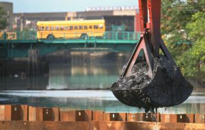 Dredging in the Gowanus Canal in Brooklyn, NY, in 1998 brought up muck laced with environmental toxins as a school bus crosses the Third Avenue Bridge. ©Mark D Phillips