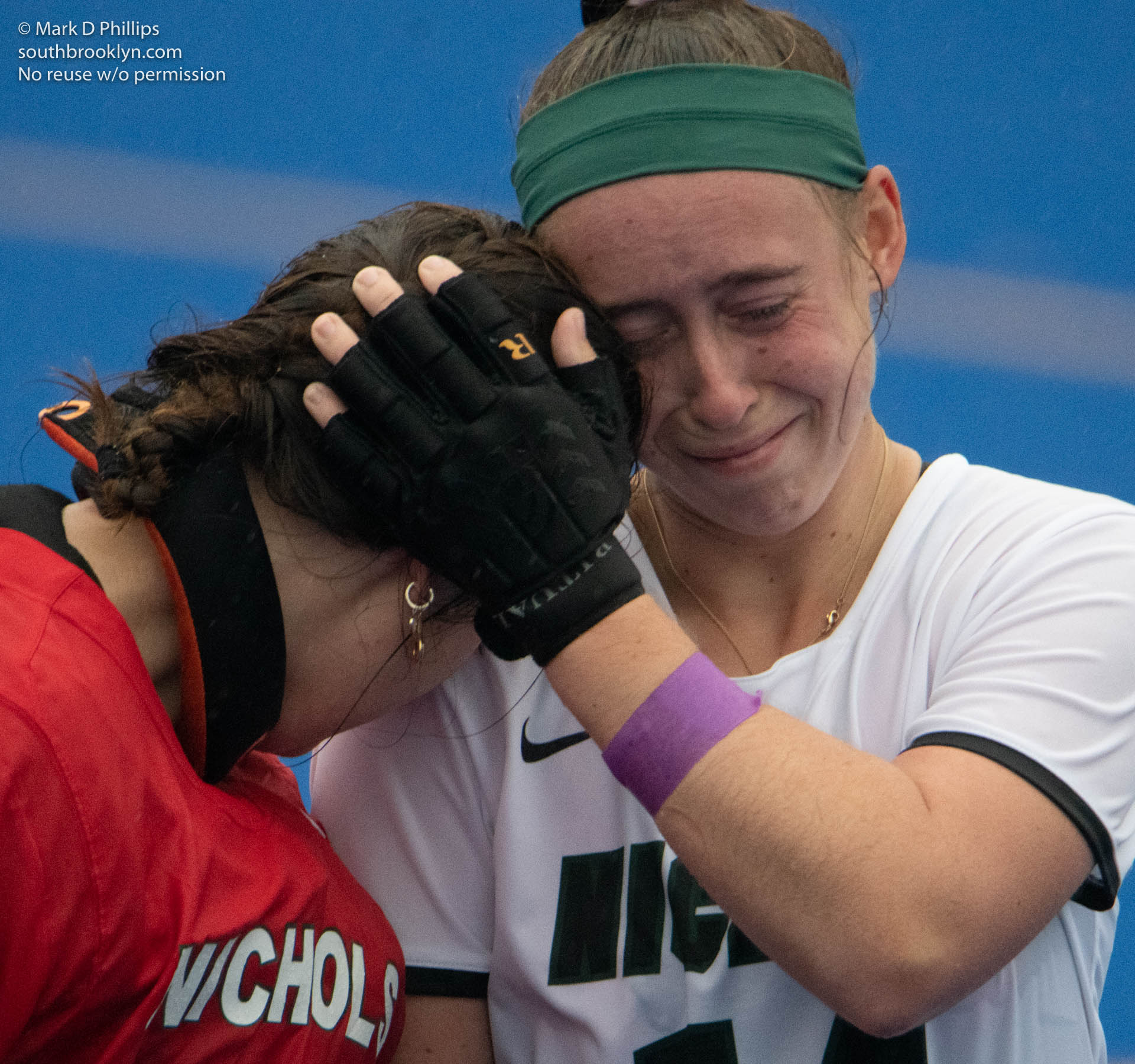 Liza Phillips hugs and cries with teammate Meghan Fuchs after Nichols College Field Hockey plays University of New England on October 30, 2021, their last game of her final season. ©Mark D Phillips