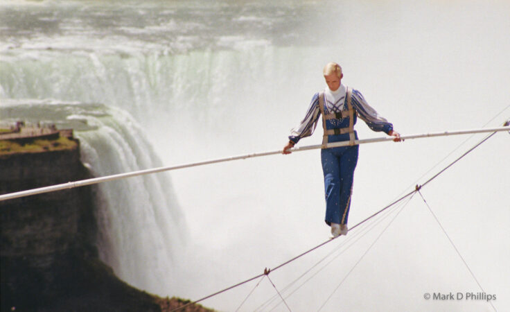 Jay Cochrane skywalks on Clifton Hill in Niagara Falls, Canada, in 2002. The first skywalk in over a hundred years went from the pinnacle of the Sheraton on the Falls Hotel to the Casino Niagara Tower at a height of 40 stories, with Niagara Falls as the backdrop. "Skywalk at Niagara" was the highest skywalk ever completed in Niagara Falls. PHOTO BY MARK D. PHILLIPS