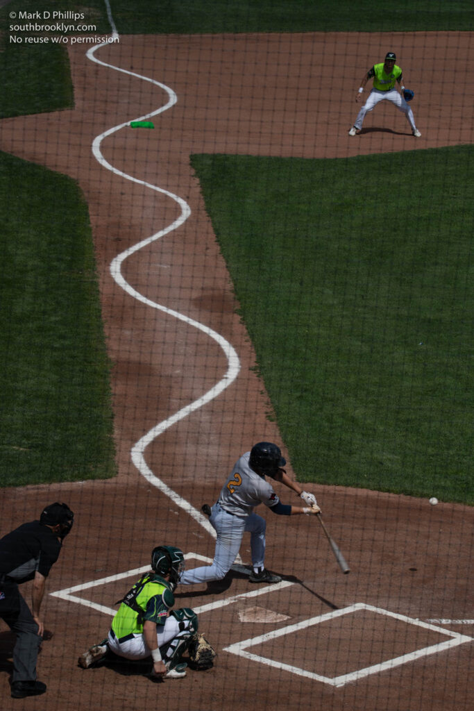 Norwich Sea Unicorns batter Zac Zyons bats the opposite way to lead off the game with Worcester Braveheart catcher Andrew Chronister during"Savannah Bannanas" style exhibition game for a stadium full of school children on June 8, 2022. Photo by Mark D Phillips