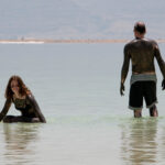 Hannah Sigurdsson drops into the water of the Dead Sea as her dad, Einar, continues further from shore. ©Mark D Phillips