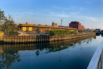 Panorama of Pig Beach on the Gowanus Canal at the Union Street Bridge as Tyler Daniel Smith joins friends at the canal. ©Mark D Phillips