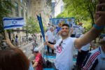 Israeli Judoka Ori Sasson, who during his career won two Olympic medals and a Maccabiah Gold, rides the Maccabiah float during the Israeli Day Parade on May 22, 2022. ©Mark D Phillips