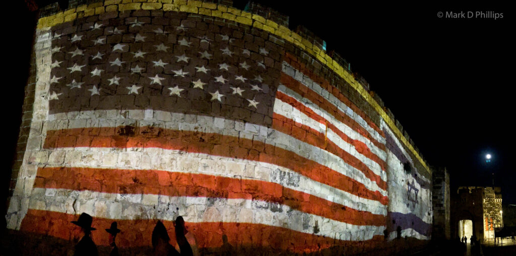 US and Israeli flags are projected on the wall of Jerusalem old city by the Jaffa Gate for a visit by President Joe Biden to Israel to attend the opening ceremony of the 21st Maccabiah Games in 2022. The symbolism after the recent move of the US Embassy is not lost. ©Mark D Phillips