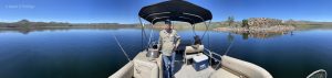 Chuck Bigger skippers our pontoon boat in Iola Basin of Blue Mesa Reservoir at nearly full pool. ©Mark D Phillips