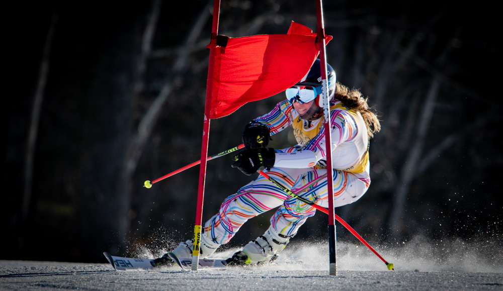 Liza Phillips blazes past a gate through late afternoon sun during Masters GS Race at Berkshire East on February 3, 2023. ©Mark D Phillipsd
